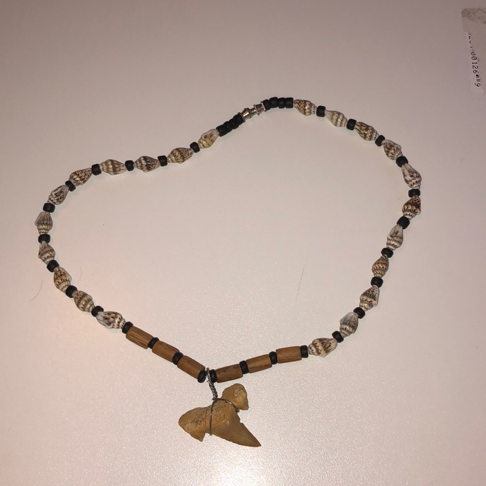 This is a beaded shark took necklace